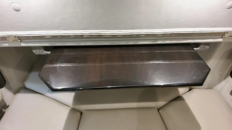 Slide: The Image of 2023 Formula 380 Super Sport Crossover OB cabin interior with wooden table and cushioned seating. - 45