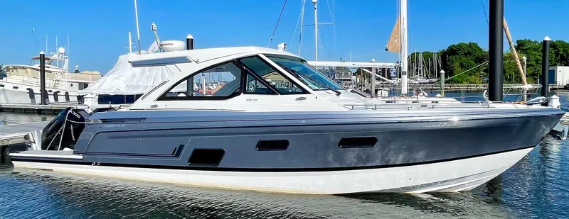 Slide: The Image of 2023 Formula 380 Super Sport Crossover OB boat docked in a marina. - 5