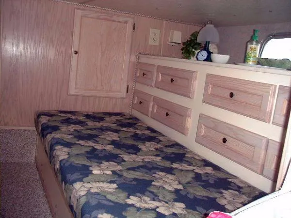 Slide: The Image of Interior of 1992 Holiday Mansion houseboat with floral bedspread and wooden cabinetry. - 10