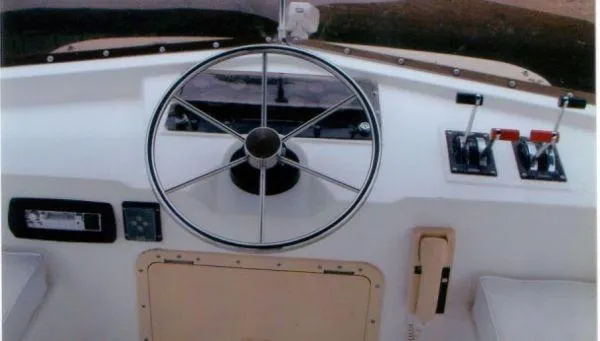 Slide: The Image of Steering wheel and controls of a 1992 Holiday Mansion houseboat. - 15