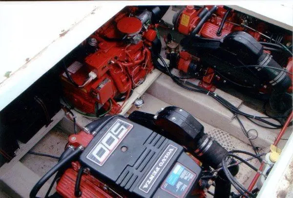 Slide: The Image of Engine compartment of a 1992 Holiday Mansion houseboat, featuring red and black mechanical components. - 16