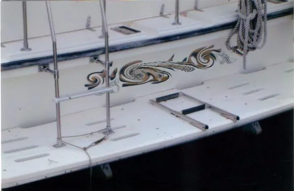 Slide: The Image of 1992 Holiday Mansion houseboat with decorative side design and dock ladder. - 17