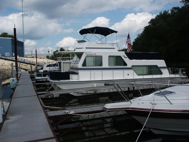 Slide: The Image of 1992 Holiday Mansion houseboat docked at marina under cloudy sky. - 18