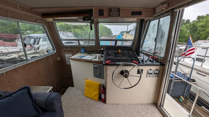 Slide: The Image of Interior of a 1992 Holiday Mansion houseboat with steering wheel and control panel. - 30