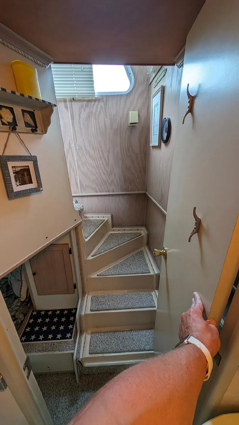 Slide: The Image of Interior view of a 1992 Holiday Mansion houseboat with a staircase and decor. - 32