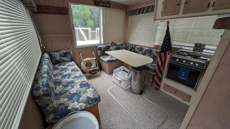 Slide: The Image of Interior of a 1992 Holiday Mansion houseboat with floral seating and kitchen area. - 34
