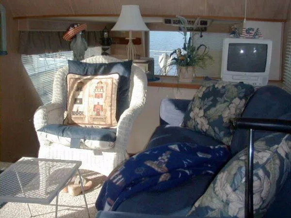 Slide: The Image of Cozy interior of a 1992 Holiday Mansion houseboat with wicker chair and floral sofa. - 4