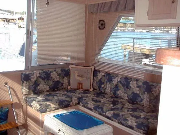 Slide: The Image of Cozy 1992 Holiday Mansion houseboat interior with floral seating and waterfront view. - 5