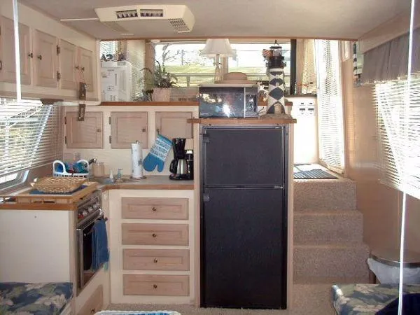 Slide: The Image of Interior of a 1992 Holiday Mansion houseboat with kitchen and cozy living space. - 8