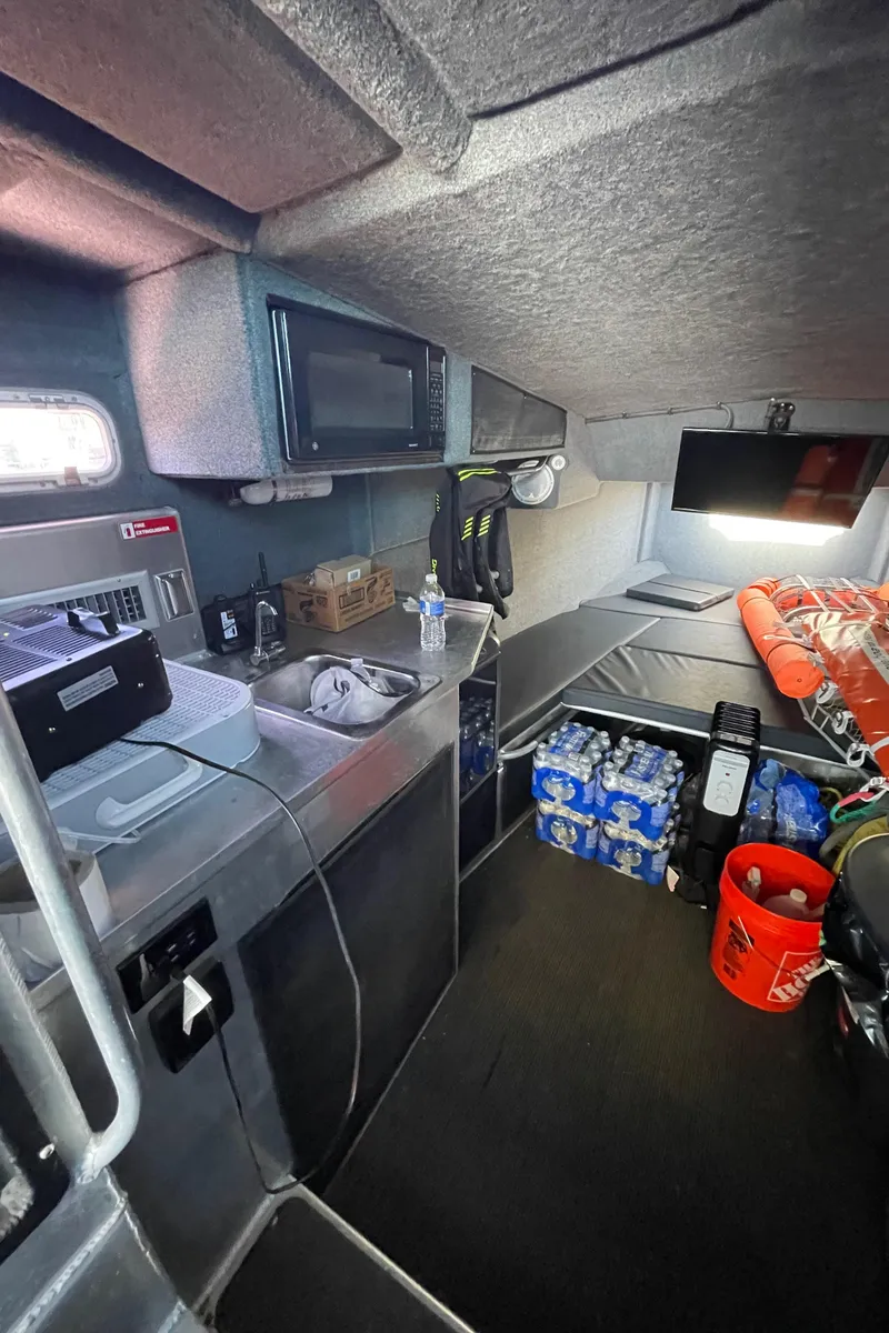 Slide: The Image of Interior of 2006 SAFE Boats 42 FC, featuring storage, sink, and emergency supplies. - 7