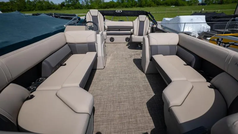 Slide: The Image of 2022 Harris CRUISER 230 SLDH pontoon boat interior with beige seating and spacious layout. - 13