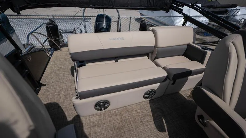 Slide: The Image of 2022 Harris CRUISER 230 SLDH boat interior with beige seating and built-in speakers. - 14