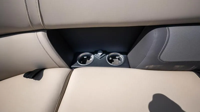Slide: The Image of Cup holders on the 2022 Harris CRUISER 230 SLDH boat's beige and gray seating. - 18