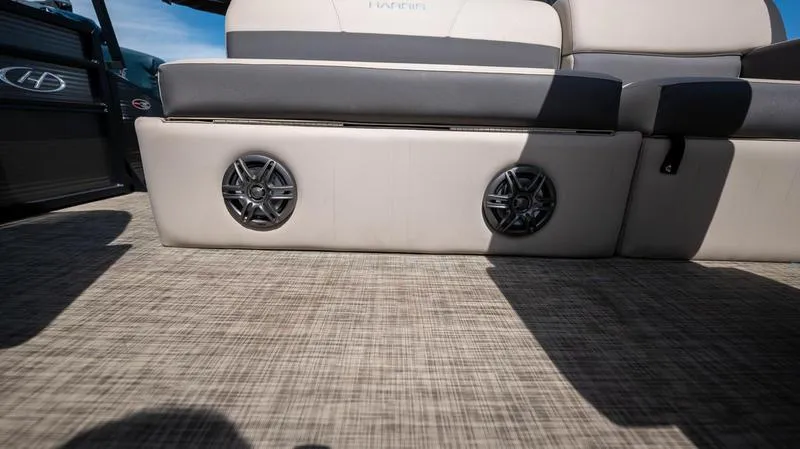 Slide: The Image of 2022 Harris CRUISER 230 SLDH boat interior with speakers and cushioned seating. - 21