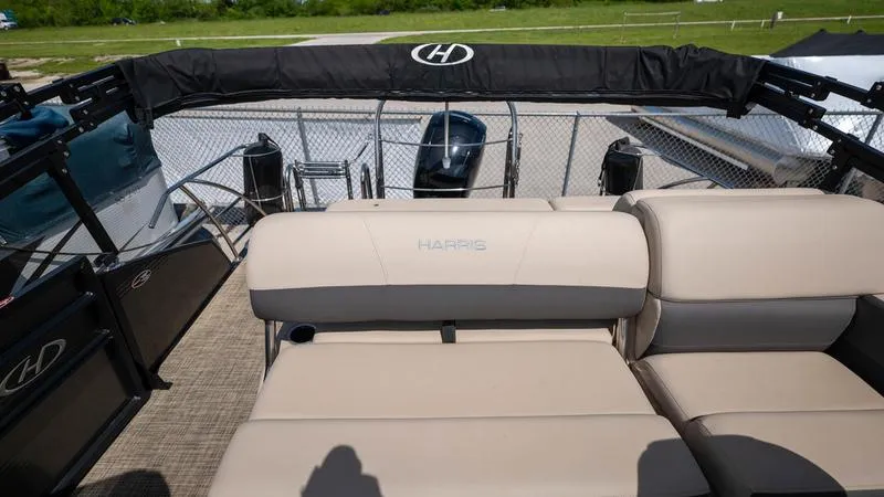 Slide: The Image of 2022 Harris CRUISER 230 SLDH pontoon boat with beige seating and black canopy. - 23