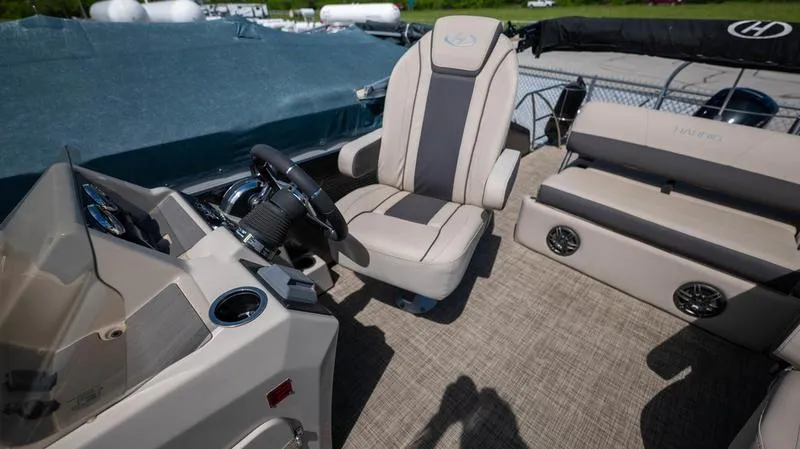 Slide: The Image of 2022 Harris CRUISER 230 SLDH boat interior with captain's chair and dashboard. - 9