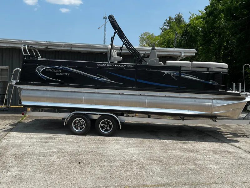 The Image of 2023 Angler Qwest 8522 Pro Family Fish pontoon boat on a trailer. - 0