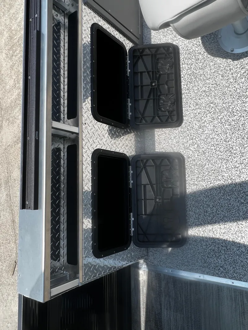 Slide: The Image of 2023 Angler Qwest 8522 Pro Family Fish storage compartments with open lids. - 15