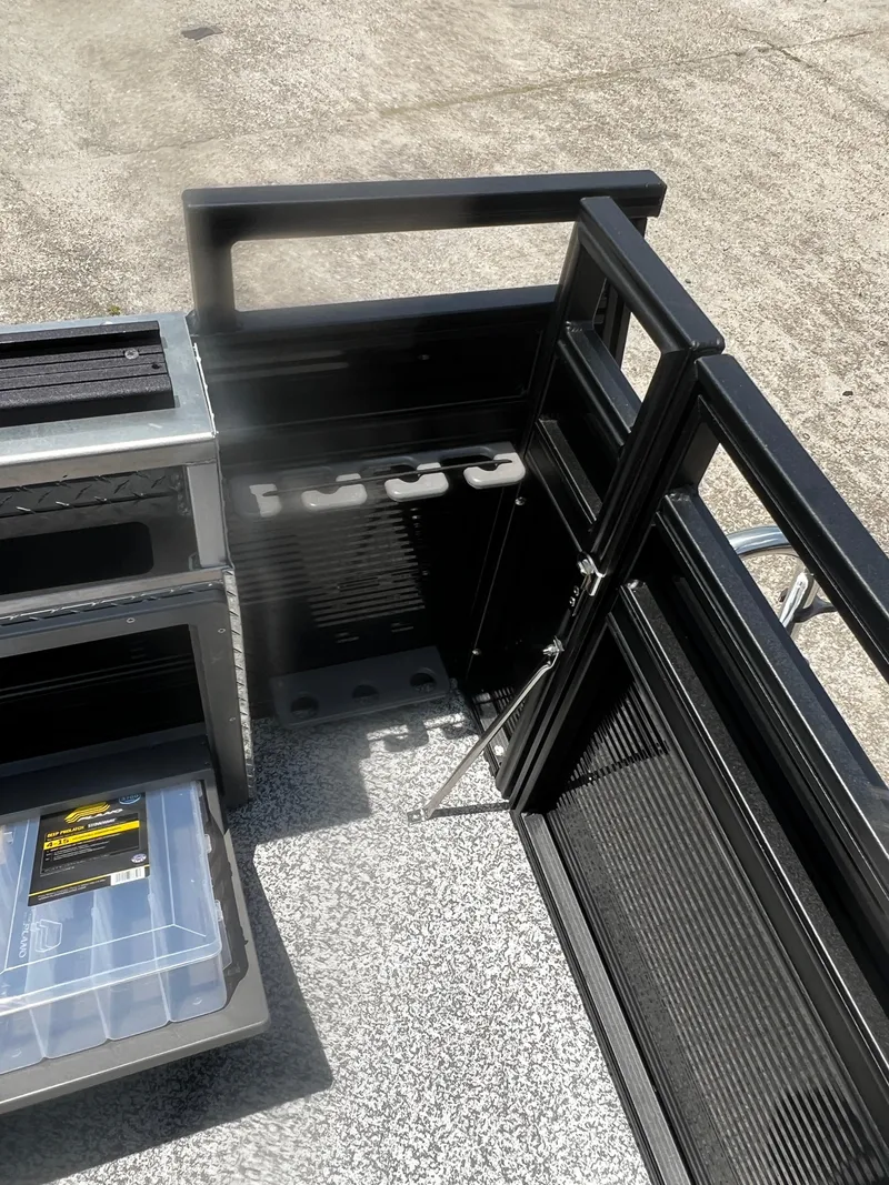 Slide: The Image of 2023 Angler Qwest 8522 Pro Family Fish boat interior with rod holders and storage compartments. - 17