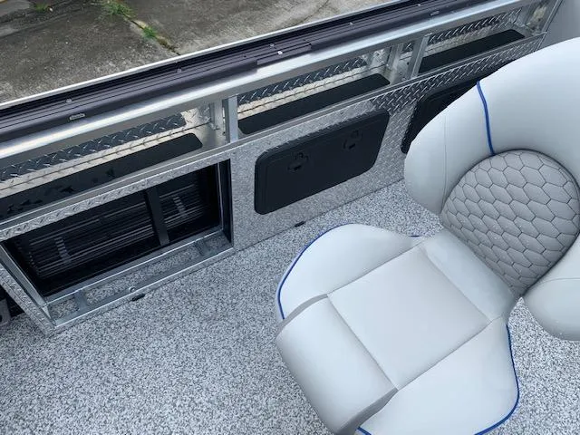 Slide: The Image of 2023 Angler Qwest 8522 Pro Family Fish boat interior with cushioned seat and storage compartments. - 22