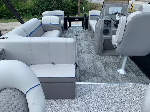 Slide: The Image of 2023 Angler Qwest 8522 Pro Family Fish boat interior with gray seating and Garmin navigation. - 24