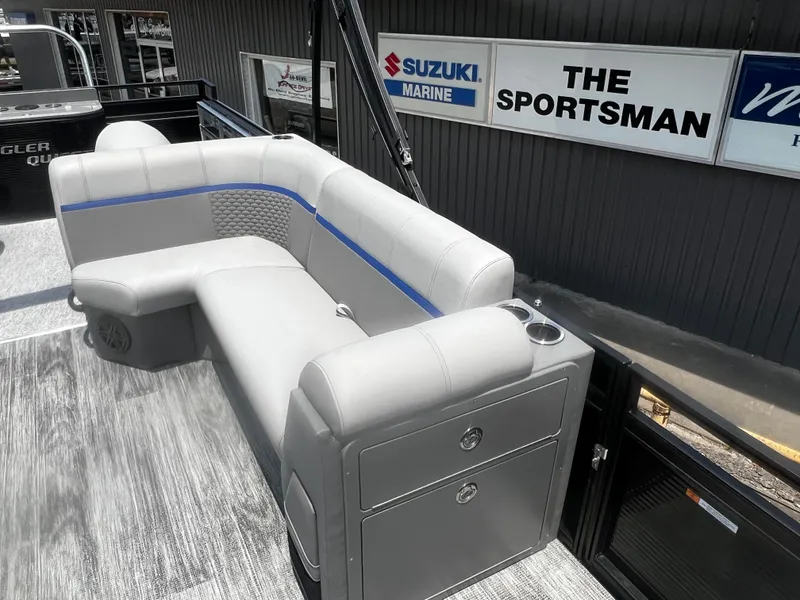 Slide: The Image of 2023 Angler Qwest 8522 Pro Family Fish boat with gray seating and storage compartments. - 3