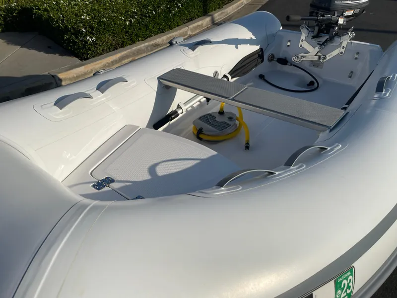 Slide: The Image of 2019 AB Inflatables Navigo 9 VS inflatable boat, white, docked on pavement. - 7