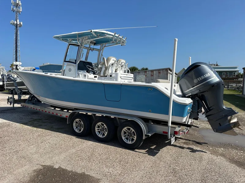 Slide: The Image of 2021 Sportsman Open 282 Center Console boat on a trailer with Yamaha outboard motor. - 1