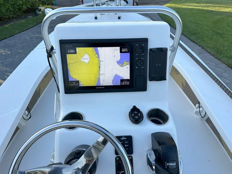 Slide: The Image of 2022 Blacktip Boatworks 18 Flats console with Garmin GPS and steering wheel. - 19