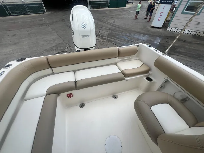 Slide: The Image of 2014 Key West 203 DFS boat with beige and white seating, Suzuki 150 outboard motor. - 14