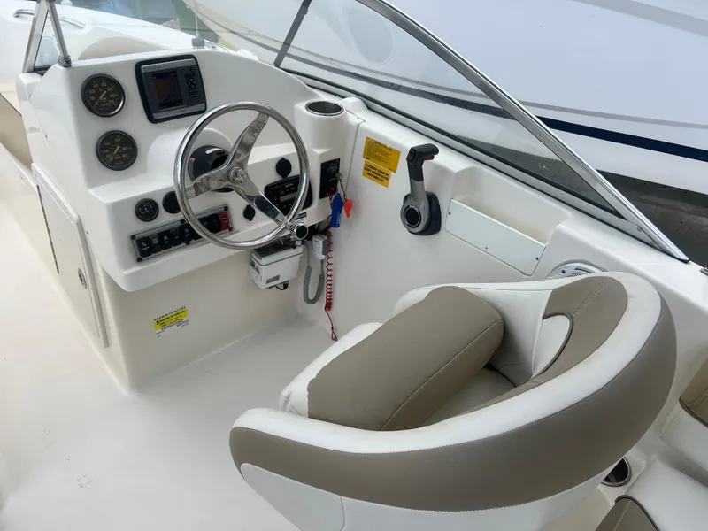 Slide: The Image of 2014 Key West 203 DFS boat cockpit with steering wheel and control panel. - 6