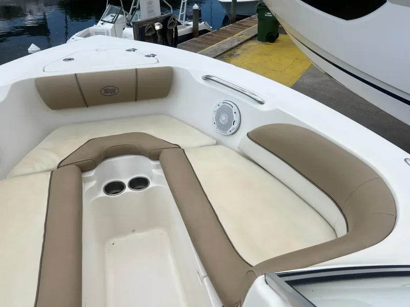 Slide: The Image of 2014 Key West 203 DFS boat with beige and white cushioned seating area. - 9