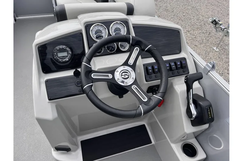 Slide: The Image of 2024 Sylvan Mirage 818 Cruise boat dashboard with steering wheel and control panel. - 11