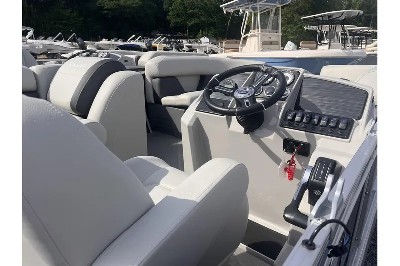 Slide: The Image of 2024 Sylvan Mirage 818 Cruise boat interior with steering console and seating. - 13