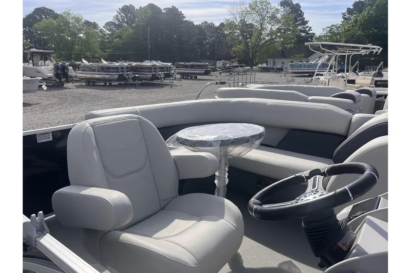 Slide: The Image of 2024 Sylvan Mirage 818 Cruise pontoon boat interior with captain's chair and steering wheel. - 14