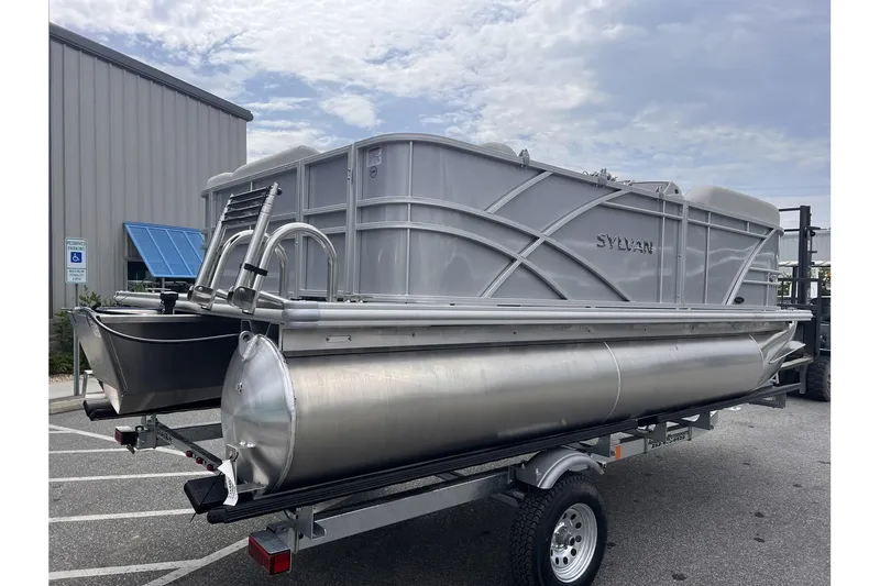 Slide: The Image of 2024 Sylvan Mirage 818 Cruise pontoon boat on trailer, parked outdoors. - 2