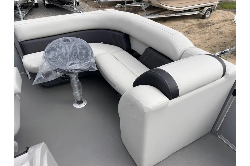 Slide: The Image of 2024 Sylvan Mirage 818 Cruise boat interior with cushioned seating and table. - 8