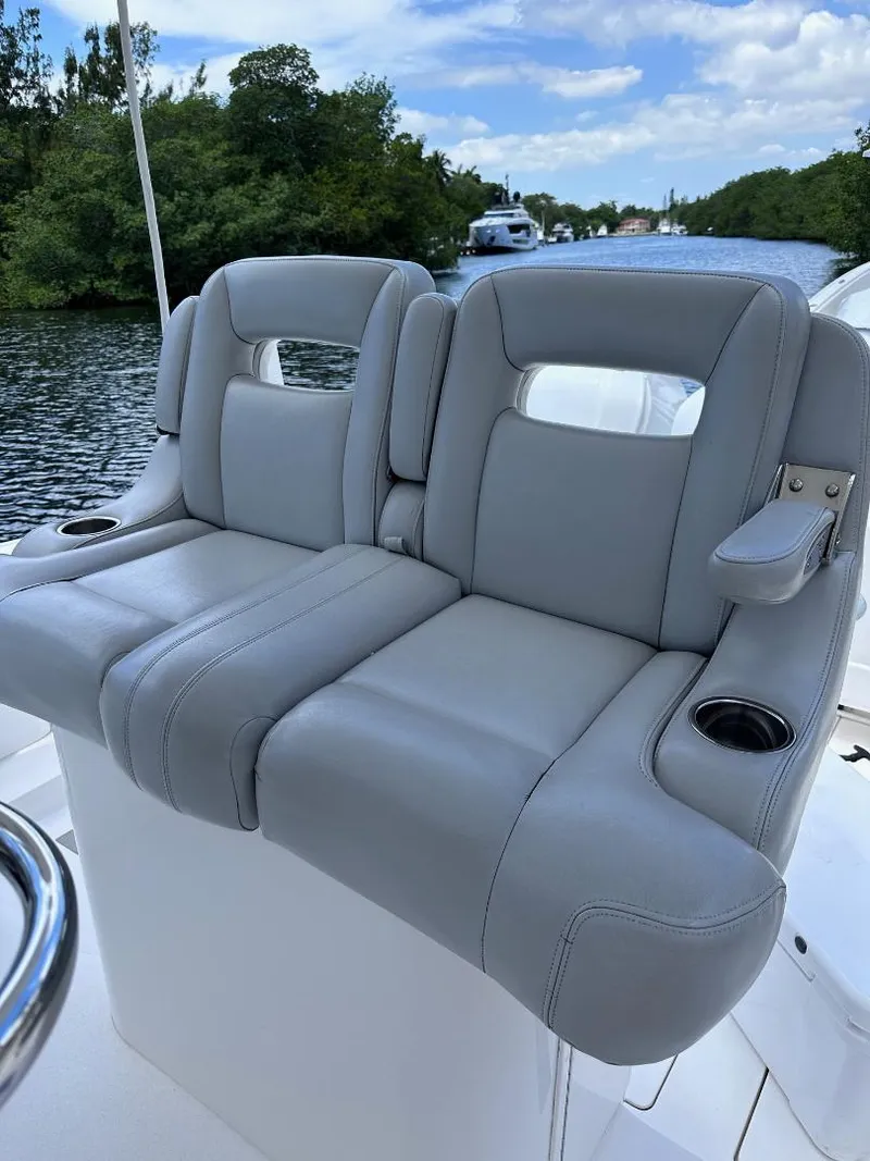 Slide: The Image of 2016 Intrepid 375 Walkaround boat with dual gray cushioned seats. - 10
