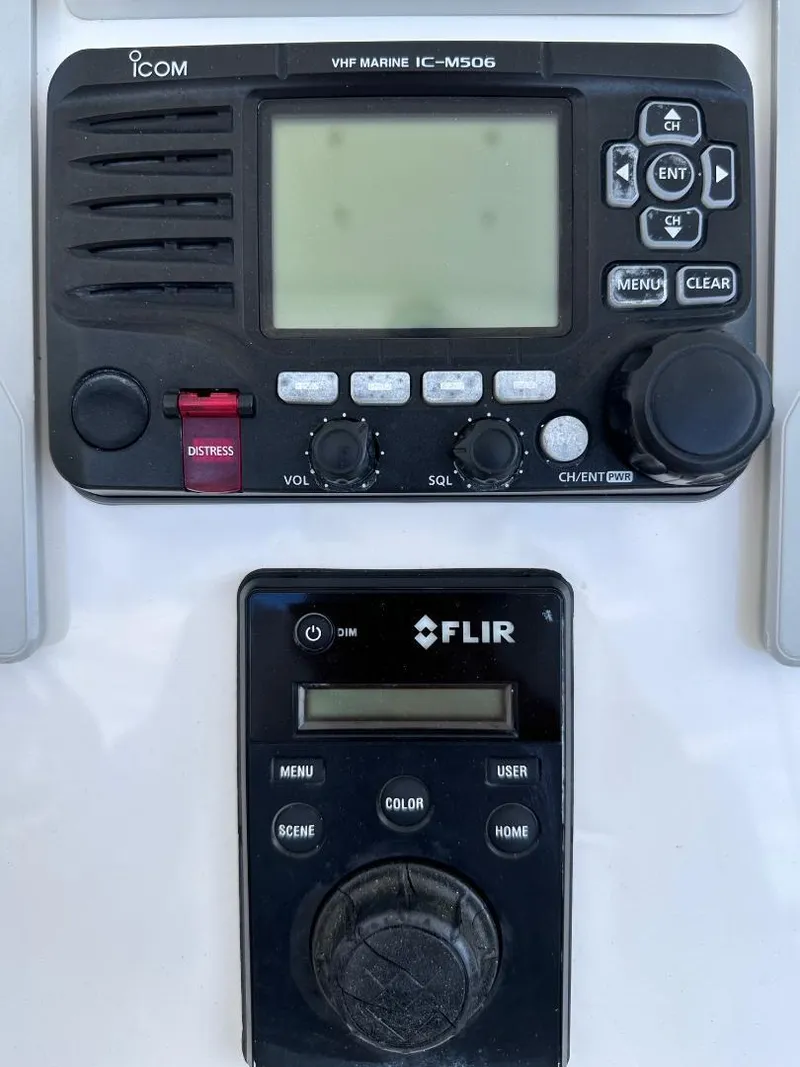 Slide: The Image of ICOM VHF Marine IC-M506 and FLIR control panel on 2016 Intrepid 375 Walkaround. - 16