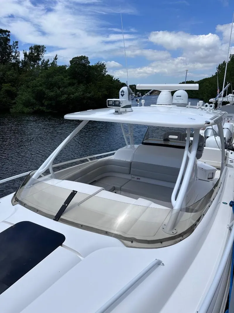Slide: The Image of 2016 Intrepid 375 Walkaround boat docked on a calm river. - 2