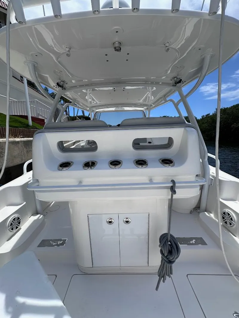 Slide: The Image of 2016 Intrepid 375 Walkaround boat interior with fishing rod holders and storage compartments. - 28