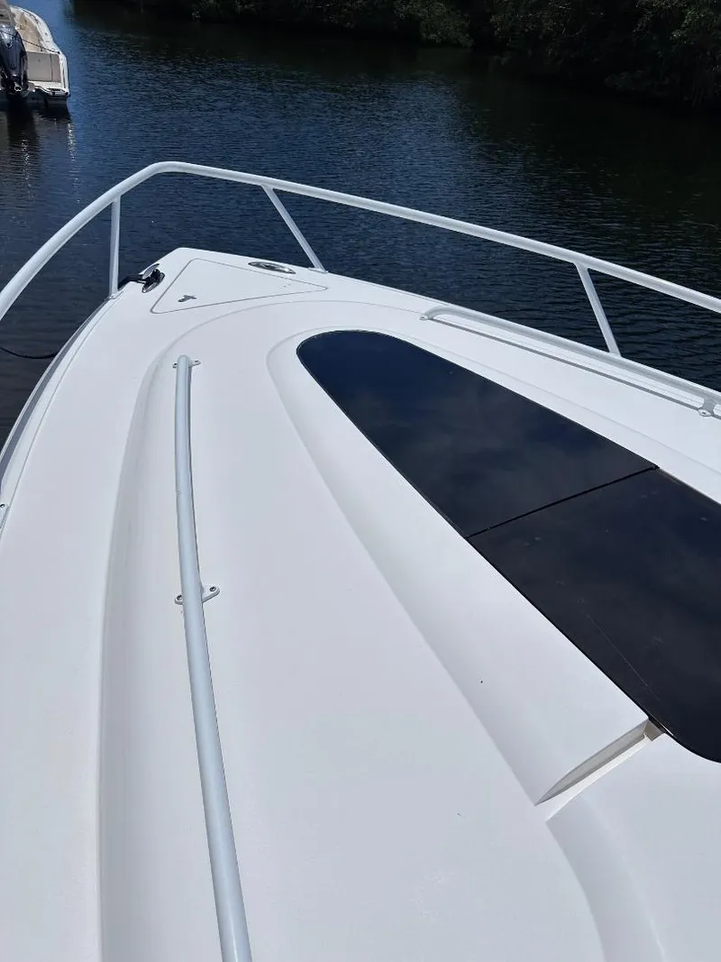 Slide: The Image of 2016 Intrepid 375 Walkaround boat deck on calm water. - 31