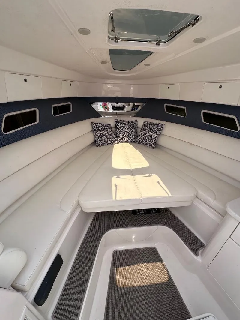 Slide: The Image of 2016 Intrepid 375 Walkaround cabin with white seating and decorative pillows. - 36