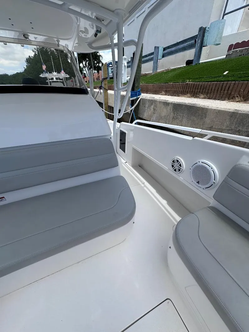 Slide: The Image of 2016 Intrepid 375 Walkaround boat interior with gray seating and white deck. - 5