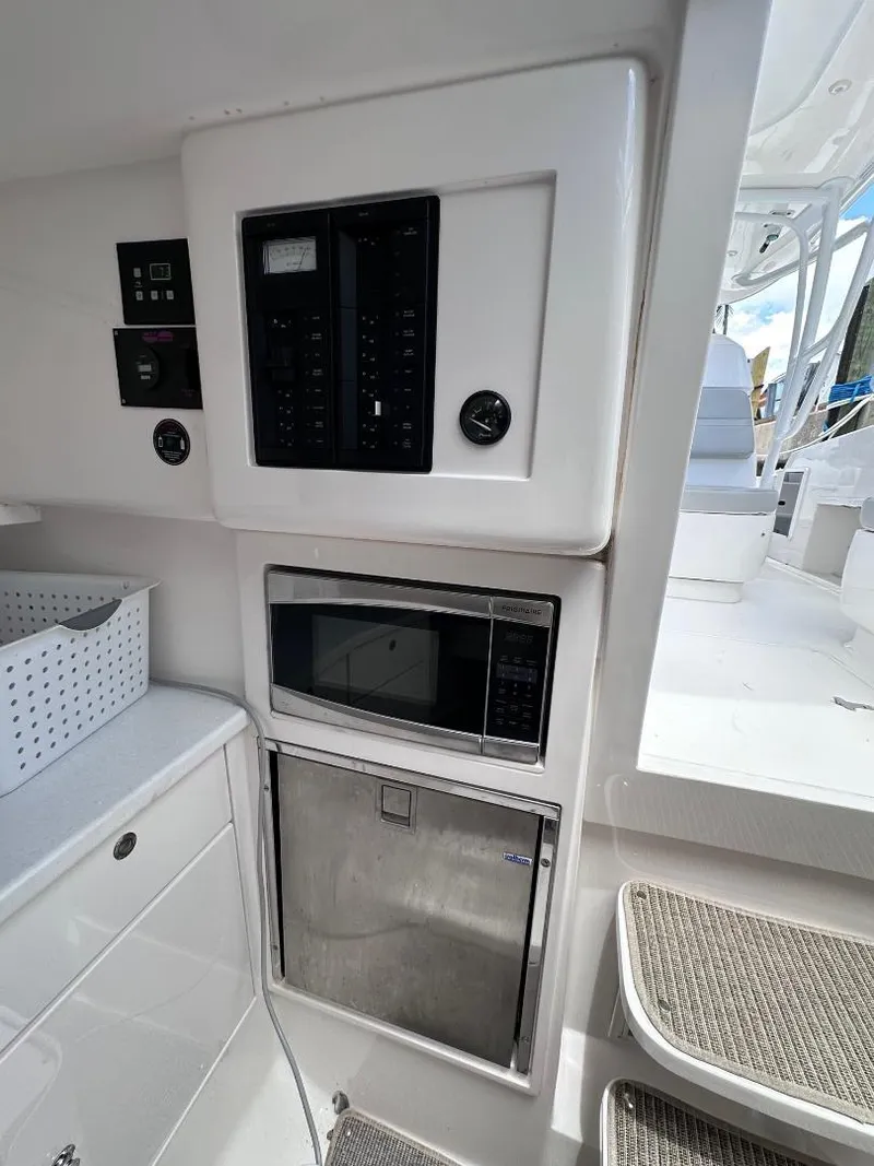 Slide: The Image of 2016 Intrepid 375 Walkaround interior with control panel, microwave, and storage. - 6
