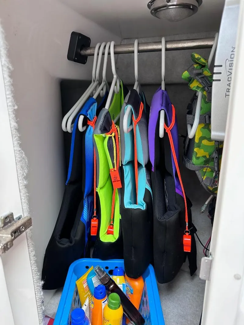 Slide: The Image of Life jackets and sunscreen in storage on a 2016 Intrepid 375 Walkaround boat. - 9