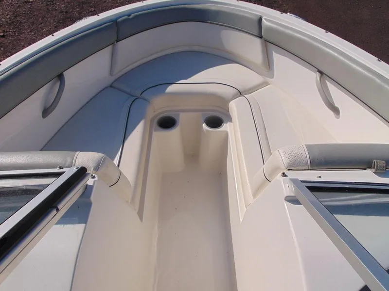 Slide: The Image of 2013 Bayliner 185 Bowrider boat interior with seating and cup holders. - 2