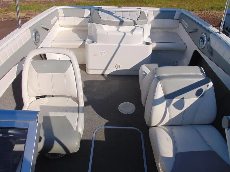 Slide: The Image of 2013 Bayliner 185 Bowrider interior with white seating and spacious layout. - 3