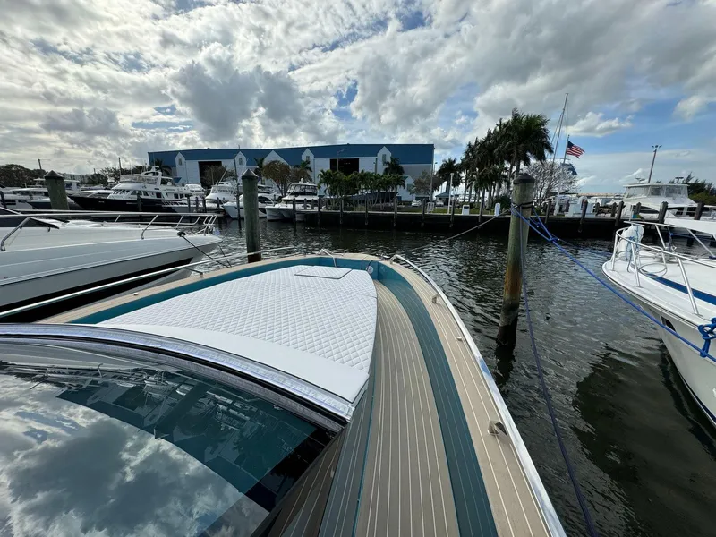 Slide: The Image of 2025 Fiart 39 Seawalker yacht docked at a marina under a cloudy sky. - 9
