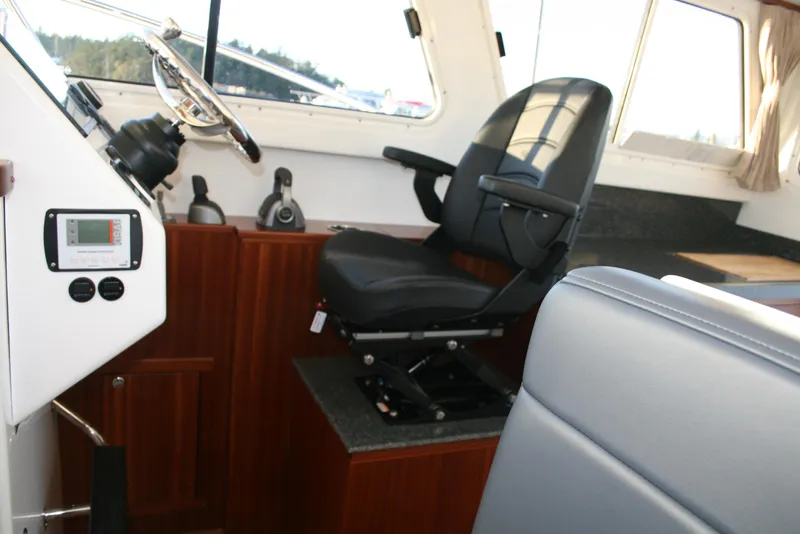 Slide: The Image of Interior of 2025 Ocean Sport Roamer 33' boat with captain's chair and controls. - 7